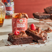 Load image into Gallery viewer, Two brownies with chocolate raspberry honey cream spread.