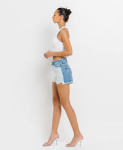 Load image into Gallery viewer, Side view of the lady wearing the High Rise Block Shorts.
