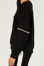 Load image into Gallery viewer, Black Pearl Sweater. The black sweater is adorned with beautiful pearls on the sleeves.
